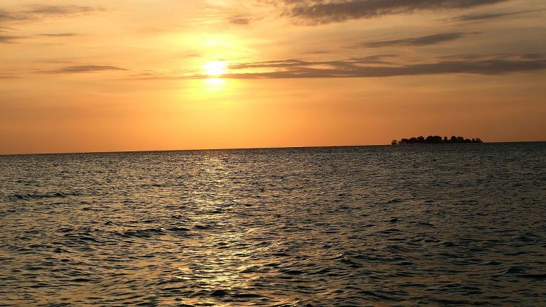 Sunset Beach Karimunjawa, a white sand beach on the west coast at sunset